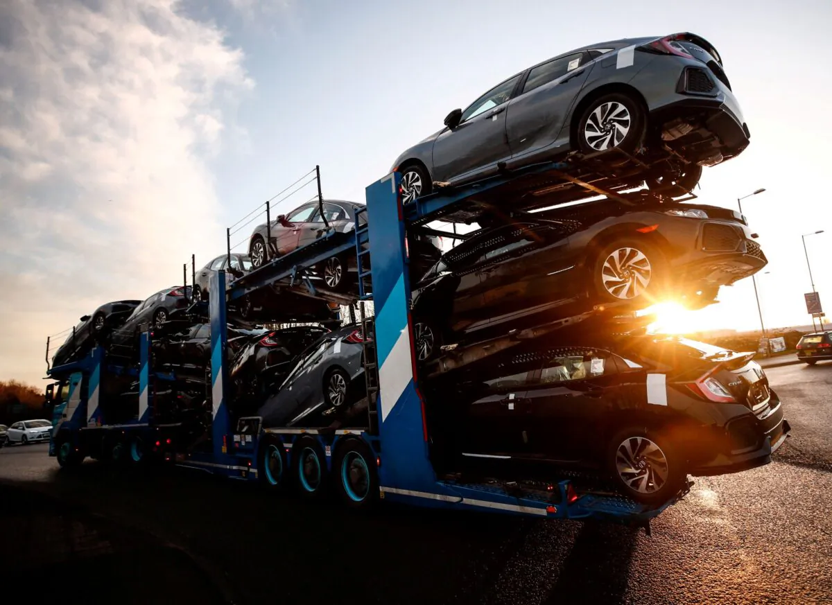 A lorry with a car carrier trailer leaves the Honda car plant in Swindon, Britain, on Feb. 18, 2019. (Eddie Keogh/Reuters)