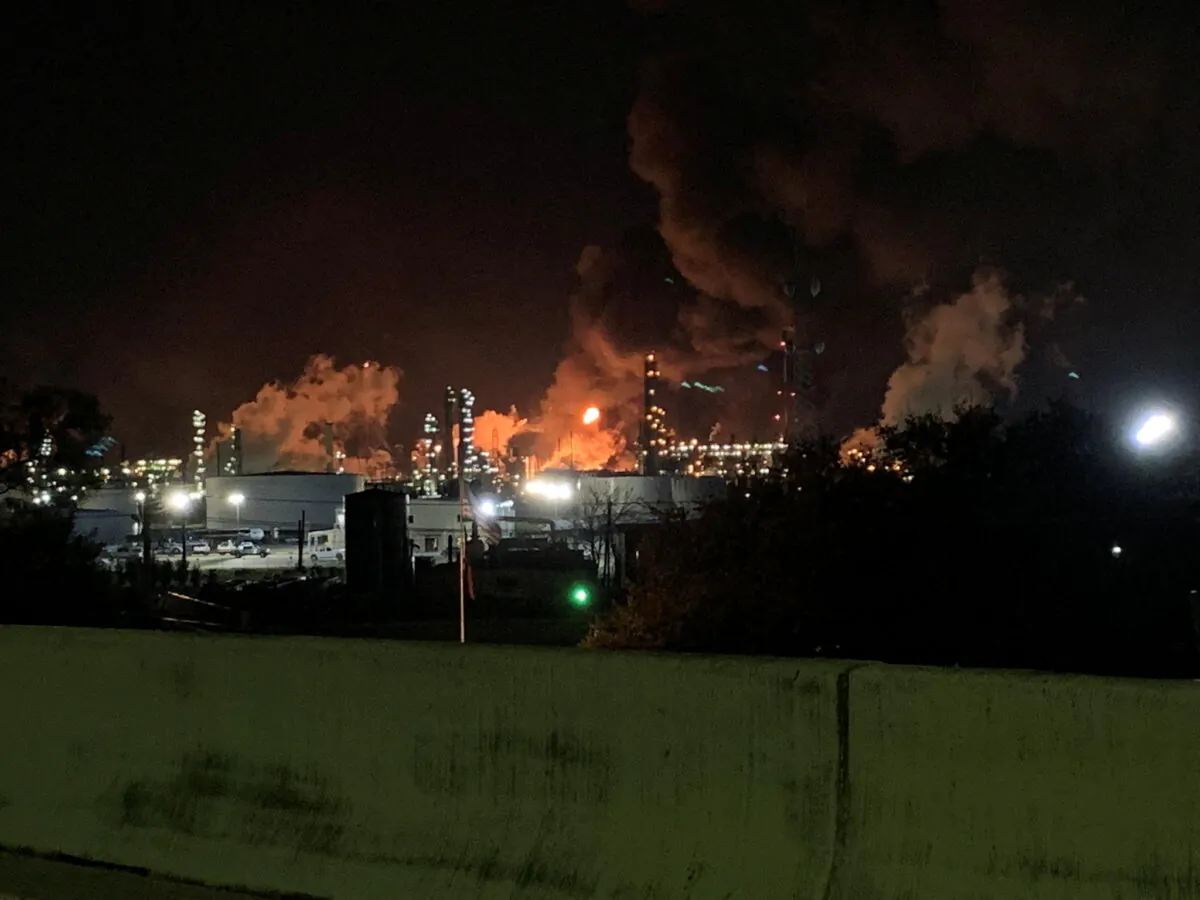 View from the road of a fire at petrochemical company ExxonMobil's refinery near Houston in Baytown, Texas, on Dec. 23, 2021, in this image obtained from social media. (Molly Fitzpatrick via Reuters)