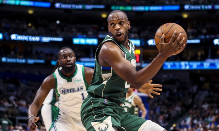 Milwaukee Bucks forward Khris Middleton (22) controls the ball as  Dallas Mavericks small forward Theo Pinson (1) defends during the first half at American Airlines Center in Dallas, on Dec. 23, 2021. (Kevin Jairaj/USA TODAY Sports via Field Level Media)
