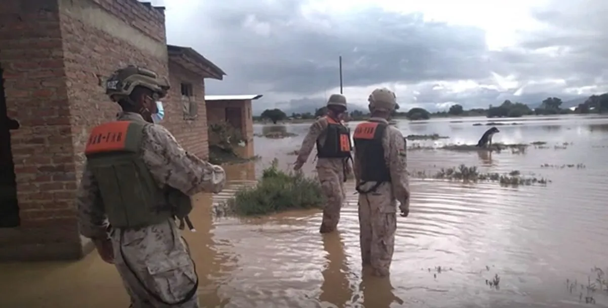A video photo showing soldiers walking next to flood waters, after the flooding in Bolivia. (AP/Screenshot via The Epoch Times)