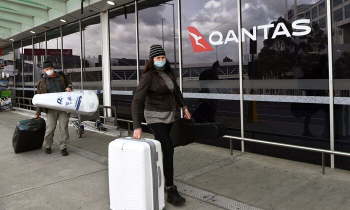 Travellers arrive at a deserted Qantas terminal at Melbourne Airport in Melbourne, Australia, on August 26, 2021 (William West/AFP via Getty Images)