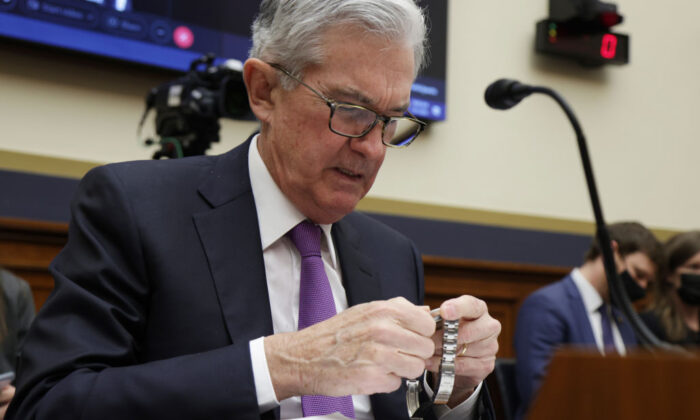 Federal Reserve Board Chairman Jerome Powell checks his watch during a hearing before the House Financial Services Committee on Capitol Hill in Washington, on Dec. 1, 2021.(Alex Wong/Getty Images)