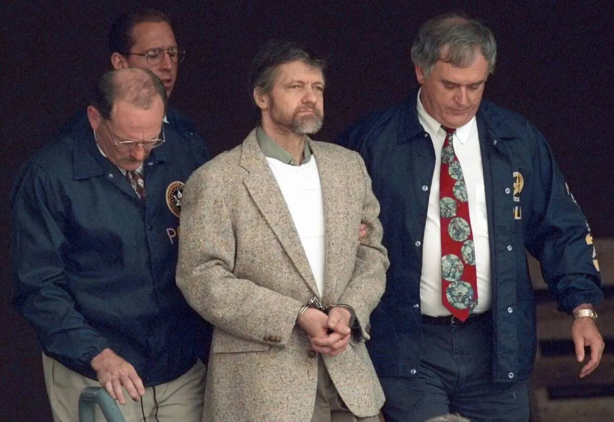 Theodore Kaczynski looks around as U.S. Marshals prepare to take him down the steps at the federal courthouse to a waiting vehicle in Helena, Mont., on June 21, 1996. (Elaine Thompson/AP Photo)
