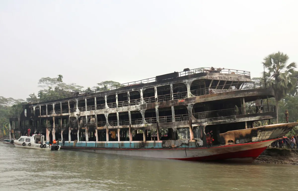 A burnt passenger ferry is seen anchored off the coast of Jhalokati district on the Sugandha River in Bangladesh, on Dec. 24, 2021. (AP Photo)