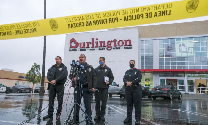 Los Angeles Police Department Public Information Officer Capt. Stacy Spell (2nd L) speaks in a press conference at the scene where two people were struck by gunfire in a shooting at a Burlington store in North Hollywood, Calif., 
 on Dec. 23, 2021. (Ringo H.W. Chiu/AP Photo)