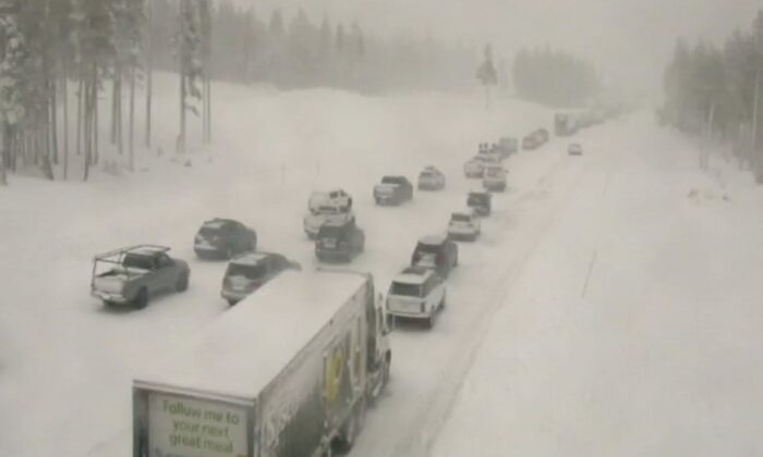 Traffic is stopped along a snow-covered Interstate 80 at Donner Summit, Calif., on Dec. 23, 2021, in a still from a Caltrans remote traffic camera video. (Caltrans via AP)