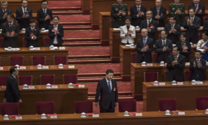 Chinese Communist Party’s head Xi Jinping, bottom center, arrives for the closing meeting of the National People's Congress (NPC) on March 15, 2019 in Beijing, China. (Kevin Frayer/Getty Images)