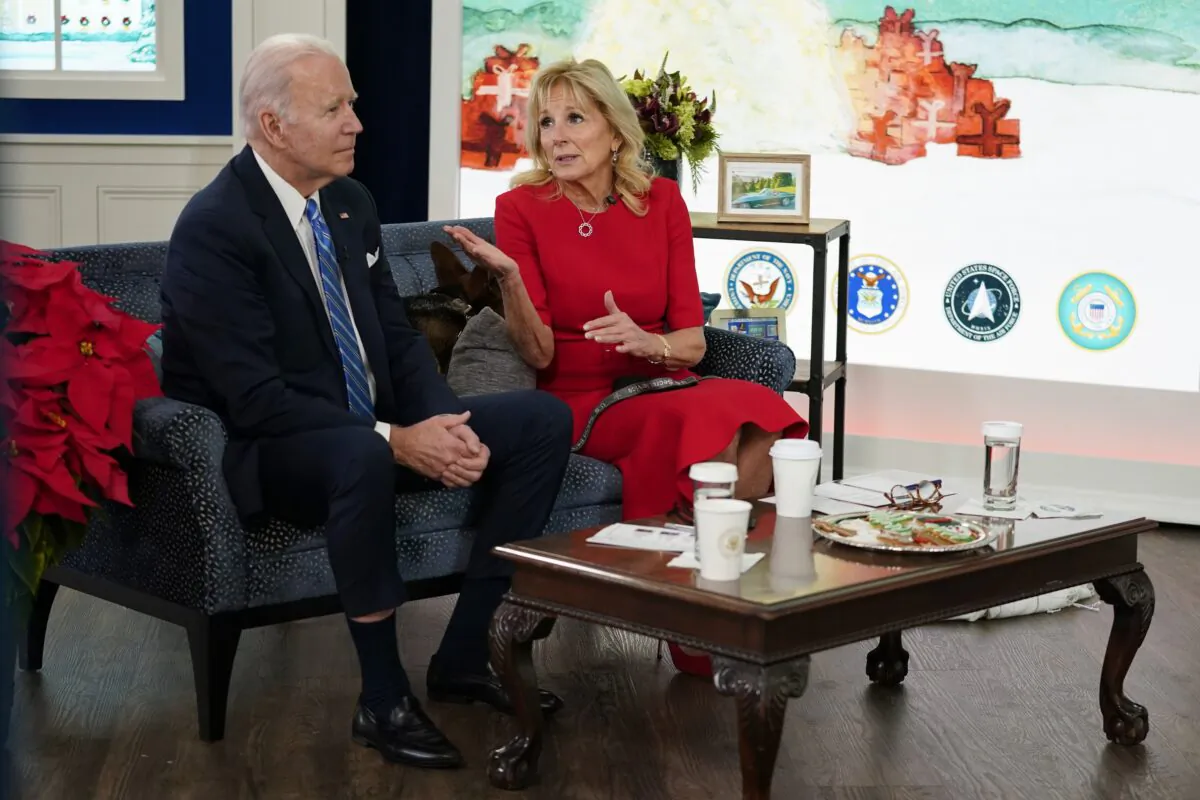 President Joe Biden and first lady Jill Biden meet virtually with service members around the world to thank them for their service and wish them a Merry Christmas, in the South Court Auditorium on the White House campus, on Dec. 25, 2021. (Carolyn Kaster/AP Photo)