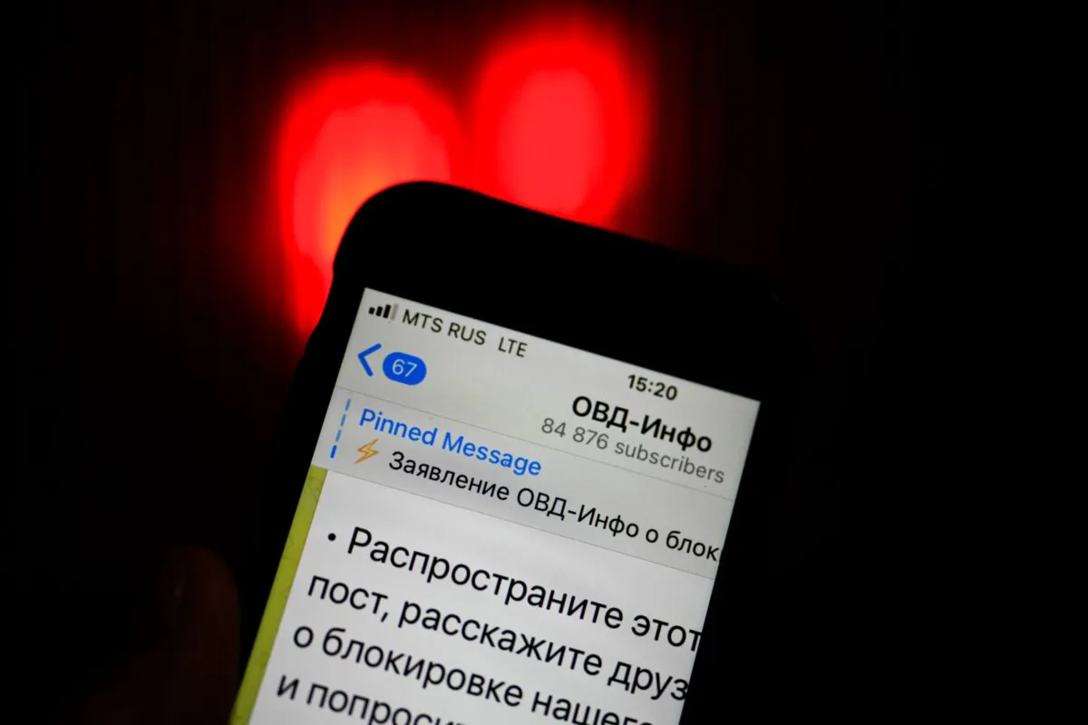 An iPhone screen shows a Telegram account of OVD-Info, a prominent legal aid group in Russia that tracks political arrests in Moscow, Russia, on Dec. 25, 2021. (Alexander Zemlianichenko/AP Photo)