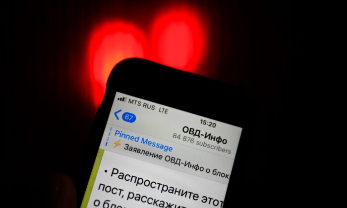 An iPhone screen shows a Telegram account of OVD-Info, a prominent legal aid group in Russia that tracks political arrests in Moscow, Russia, on Dec. 25, 2021. (Alexander Zemlianichenko/AP Photo)