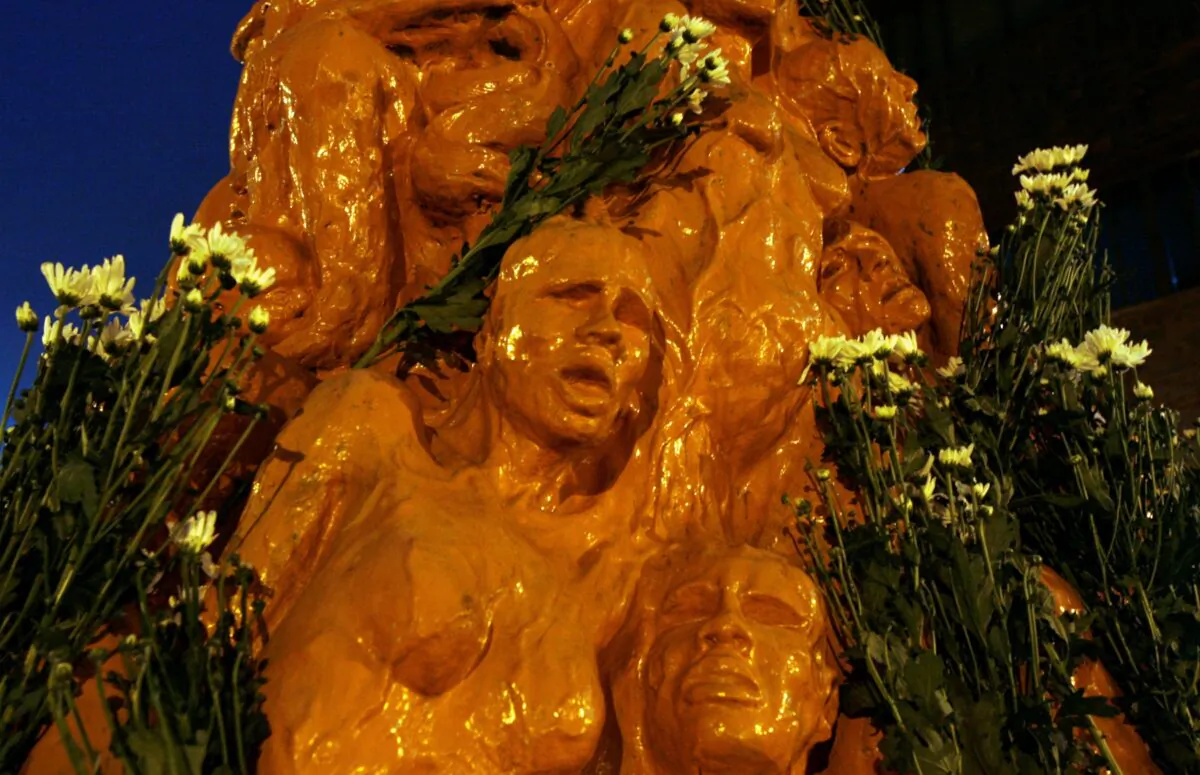 Flowers are laid on the "Pillar of Shame—A memorial for Tiananmen" by Danish artist Jens Galschiot, during a candlelight vigil at the University of Hong Kong, on June 3, 2009. (Bobby Yip/Reuters)