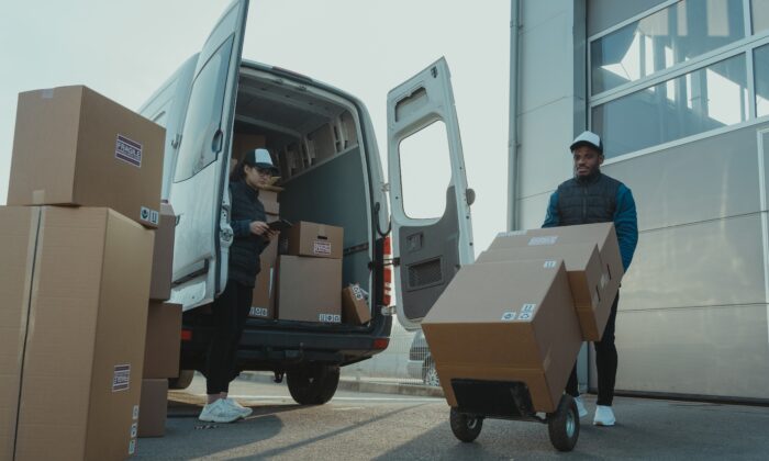 Stock photo of workers working for a delivery company. (Tima Miroshnichenko/Pexels)