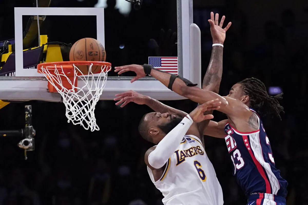 Brooklyn Nets forward Nic Claxton (33) dunks over Los Angeles Lakers forward LeBron James (6) during the second half of an NBA basketball game in Los Angeles on Dec. 25, 2021. (AP Photo/Ashley Landis)