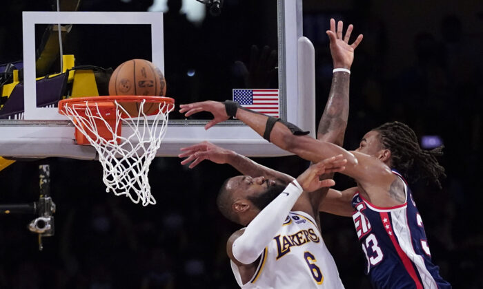 Brooklyn Nets forward Nic Claxton (33) dunks over Los Angeles Lakers forward LeBron James (6) during the second half of an NBA basketball game in Los Angeles on Dec. 25, 2021. (AP Photo/Ashley Landis)