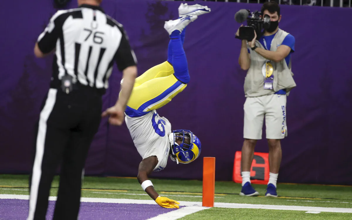 Los Angeles Rams’ Brandon Powell flips into the end zone during a 61-yard punt return for a touchdown in the second half of an NFL football game against the Minnesota Vikings on Minneapolis on Dec. 26, 2021. (AP Photo/Bruce Kluckhohn)
