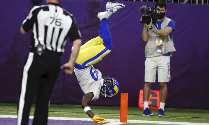 Los Angeles Rams’ Brandon Powell flips into the end zone during a 61-yard punt return for a touchdown in the second half of an NFL football game against the Minnesota Vikings on Minneapolis on Dec. 26, 2021. (AP Photo/Bruce Kluckhohn)