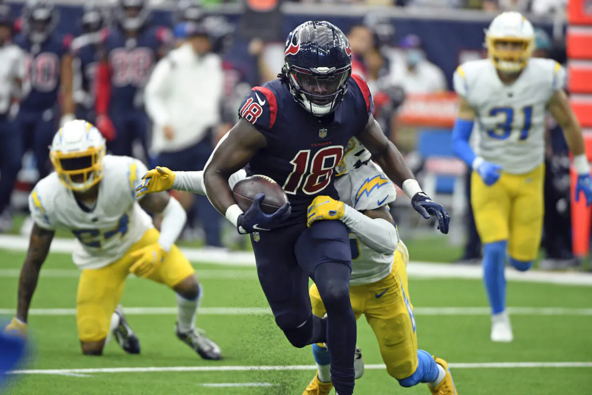 Houston Texans wide receiver Chris Conley (18) is tackled by Los Angeles Chargers' Asante Samuel Jr. after catching a pass during the second half of an NFL football game in Houston on Dec. 26, 2021. (AP Photo/Justin Rex)