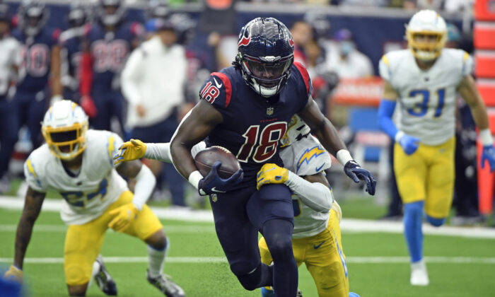 Houston Texans wide receiver Chris Conley (18) is tackled by Los Angeles Chargers' Asante Samuel Jr. after catching a pass during the second half of an NFL football game in Houston on Dec. 26, 2021. (AP Photo/Justin Rex)