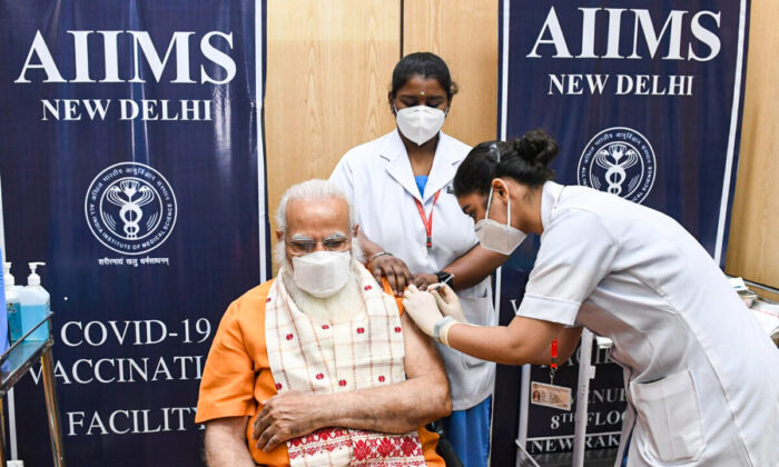 India's Prime Minister Narendra Modi receives his second dose of a coronavirus disease (COVID-19) vaccine at the All India Institute of Medical Sciences (AIIMS) hospital in New Delhi, India, April 8, 2021. India's Press Information (Bureau/Handout via Reuters)
