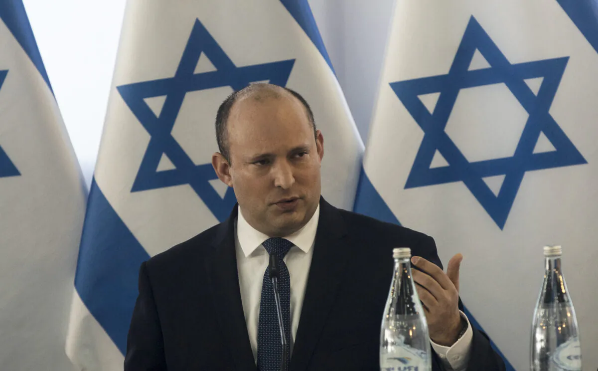 Israeli Prime Minister Naftali Bennett speaks at the weekly cabinet meeting in Kibbutz Mevo Hama in the Israeli-occupied Golan Heights, on Dec. 26, 2021. (Nir Elias/Pool via AP)