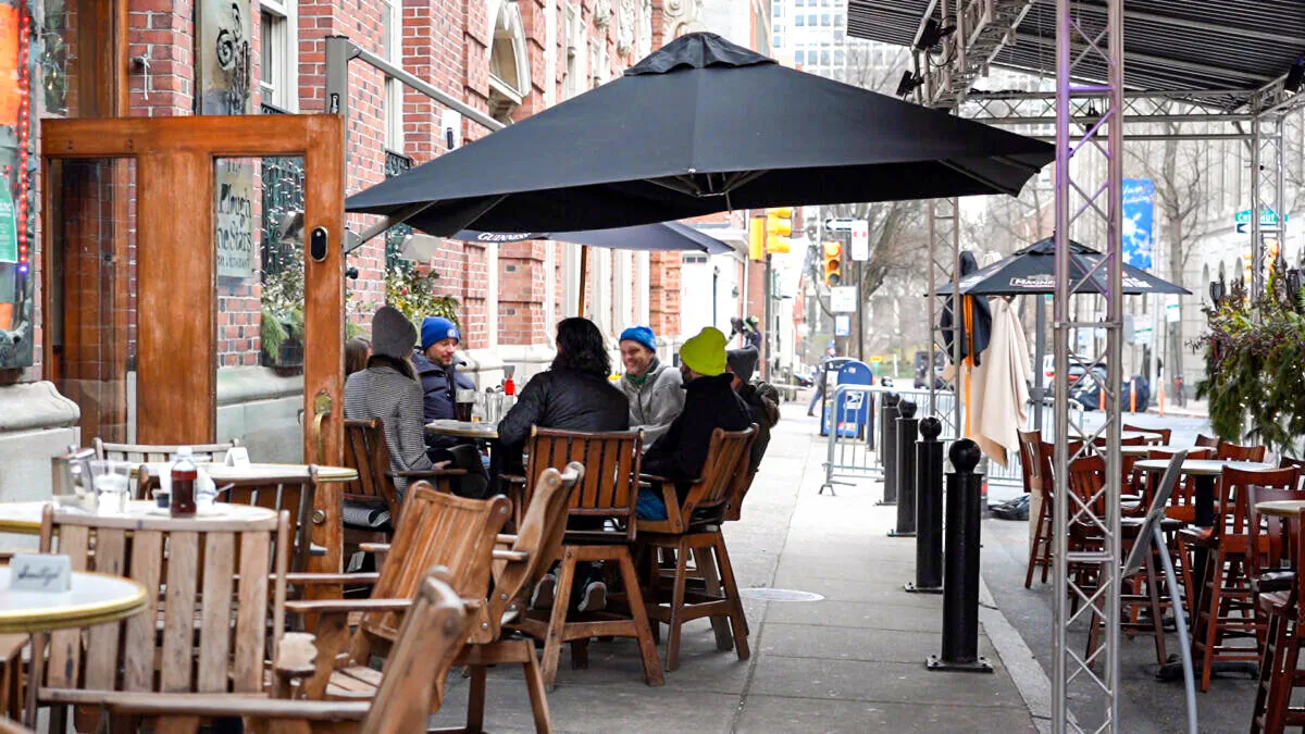 People are eating at the outdoor dining area of a restaurant in Philadelphia, Pa., on Dec. 21, 2021 (William Huang/The Epoch Times)