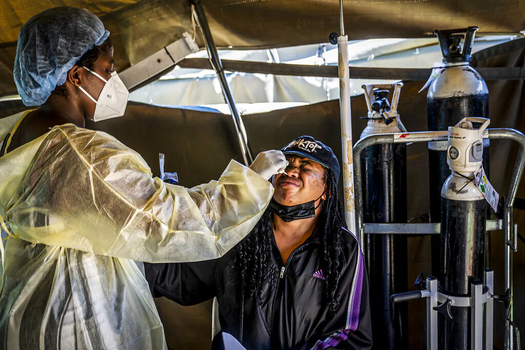 A woman is tested for COVID-19 at the Lenasia South Hospital, near Johannesburg, South Africa, Wednesday, Dec. 1, 2021. (AP Photo/ Shiraaz Mohamed)