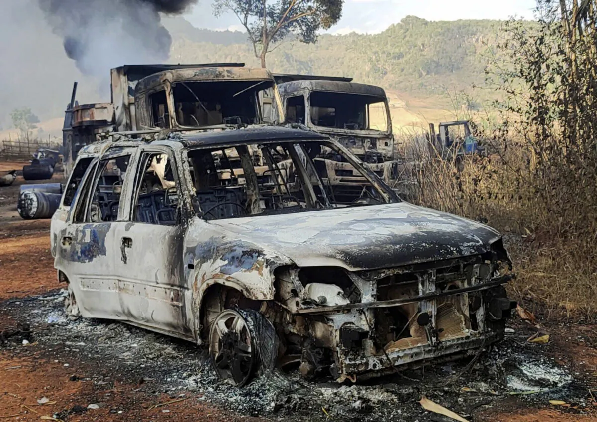 Vehicles smolder in Hpruso township, Kayah state, Myanmar, on Dec. 24, 2021. (KNDF via AP)