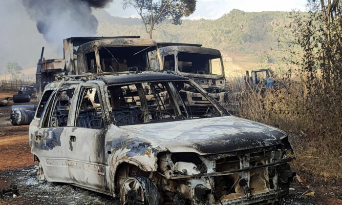 Vehicles smolder in Hpruso township, Kayah state, Myanmar, on Dec. 24, 2021. (KNDF via AP)