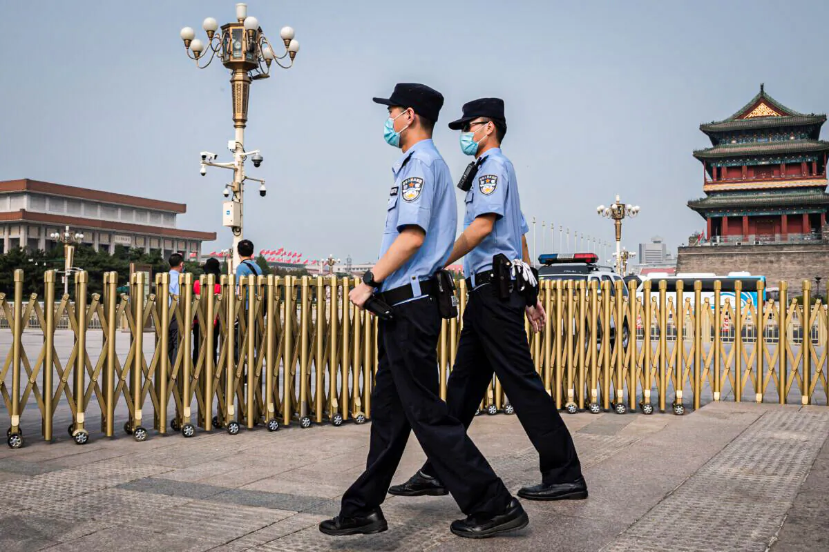 Police officers patrol an area outside Beijing's Tiananmen Square on World Press Freedom Day on May 3, 2020. (Nicolas Asfouri/AFP via Getty Images)
