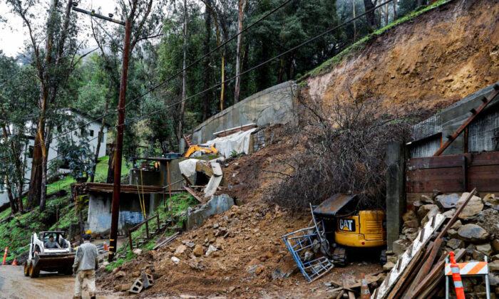 Workers clear a mudslide from a double lot on Westover Drive in Oakland, Calif., on Dec. 23, 2021. (Jane Tyska/Bay Area News Group via AP)