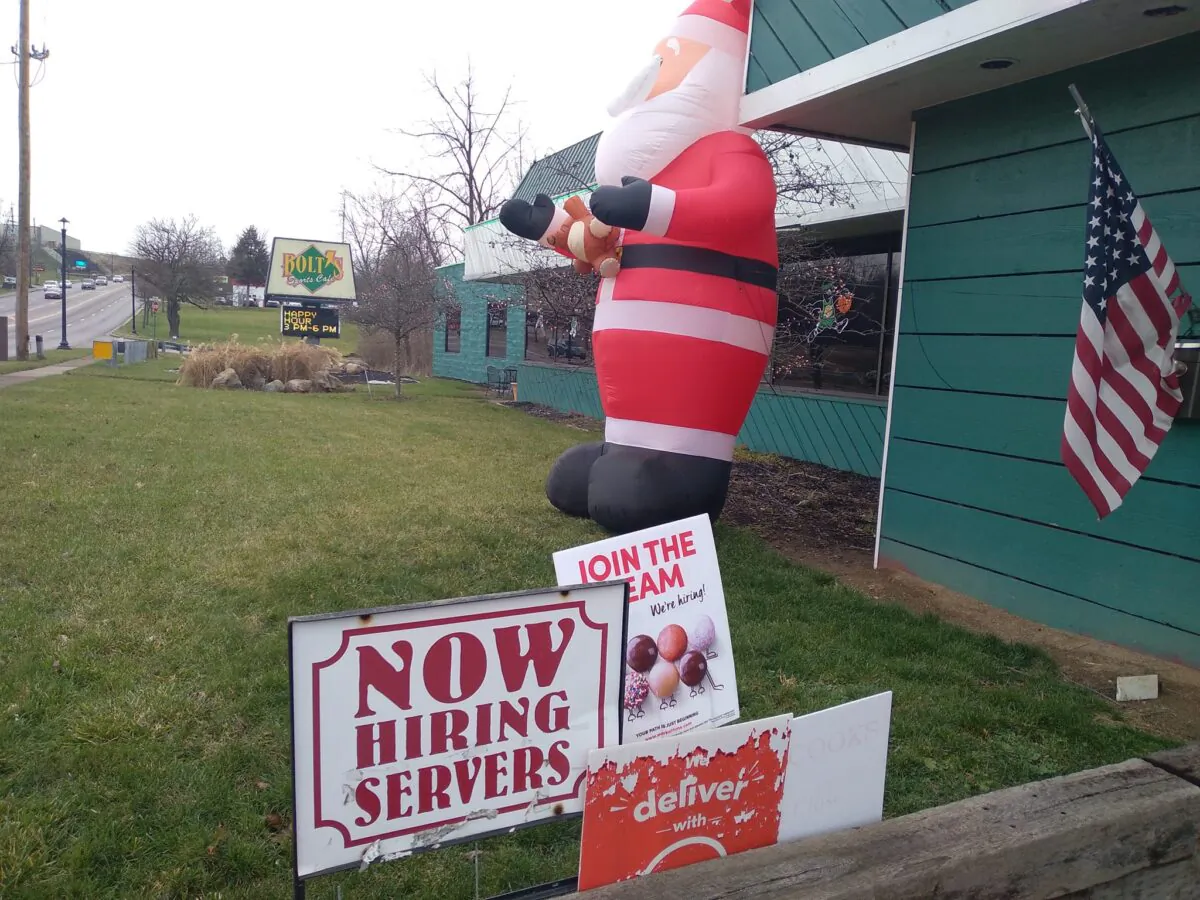 A hiring sign for servers in front of Bolt's Sports Cafe, in Englewood north of Dayton, on Dec. 27, 2021. (Michael Sakal/Epoch Times)