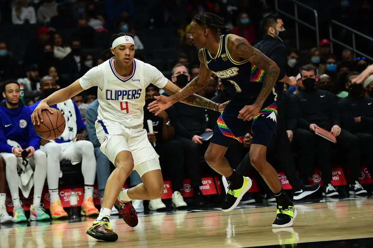 Los Angeles Clippers guard Brandon Boston Jr. (4) moves the ball against Denver Nuggets guard Bones Hyland (3), during an NBA game at Crypto.com Arena, in Los Angeles on Dec. 26, 2021. (Gary A. Vasquez/USA TODAY Sports via Field Level Media)