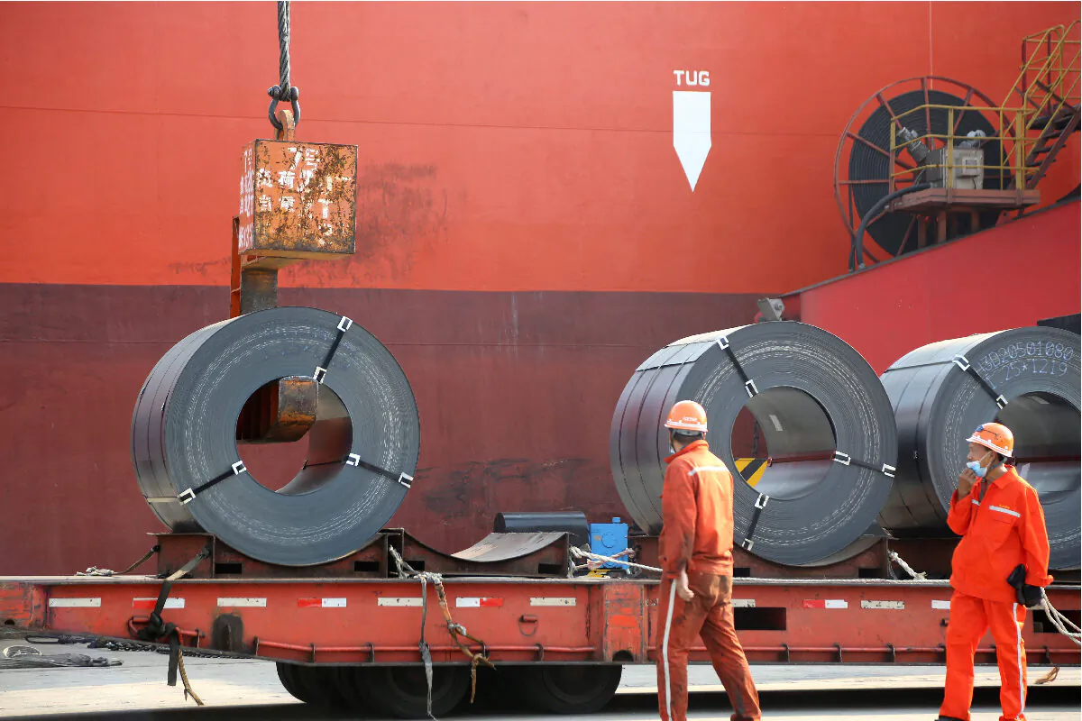 Workers load steel products for export to a cargo ship at a port in Lianyungang, Jiangsu Province, China, on May 27, 2020. (China Daily via Reuters)