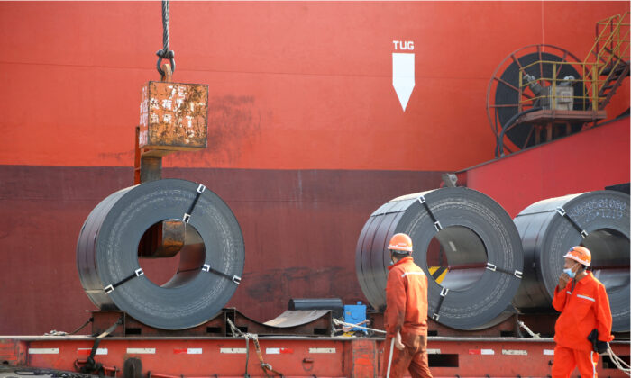 Workers load steel products for export to a cargo ship at a port in Lianyungang, Jiangsu Province, China, on May 27, 2020. (China Daily via Reuters)