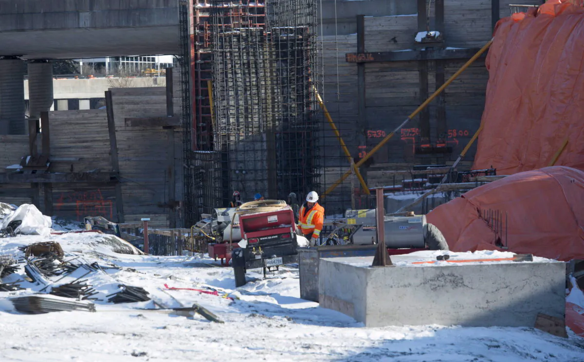 A worker is seen on a construction site for a light rail train station being built in Ottawa on Jan. 13, 2016. (The Canadian Press/Adrian Wyld)