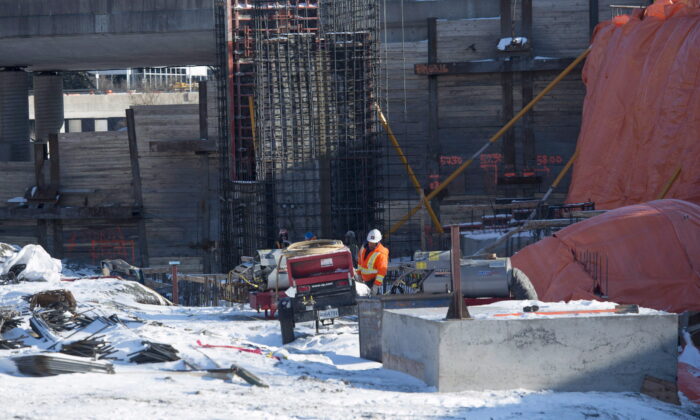 A worker is seen on a construction site for a light rail train station being built in Ottawa on Jan. 13, 2016. (The Canadian Press/Adrian Wyld)