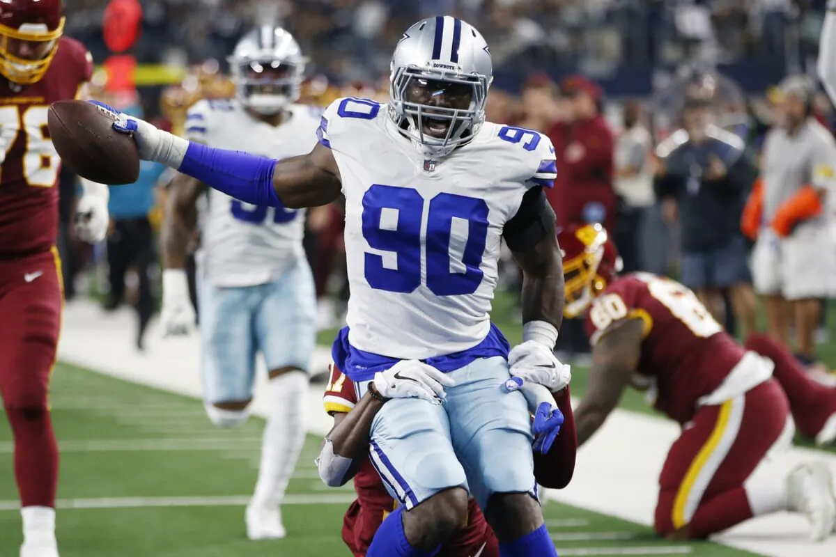 Dallas Cowboys defensive end Demarcus Lawrence (90) returns an interception for a touchdown in the first quarter against the Washington Football Team at AT&T Stadium, in Arlington, Texas, on Dec. 26, 2021. (Tim Heitman/USA TODAY Sports via Field Level Media)