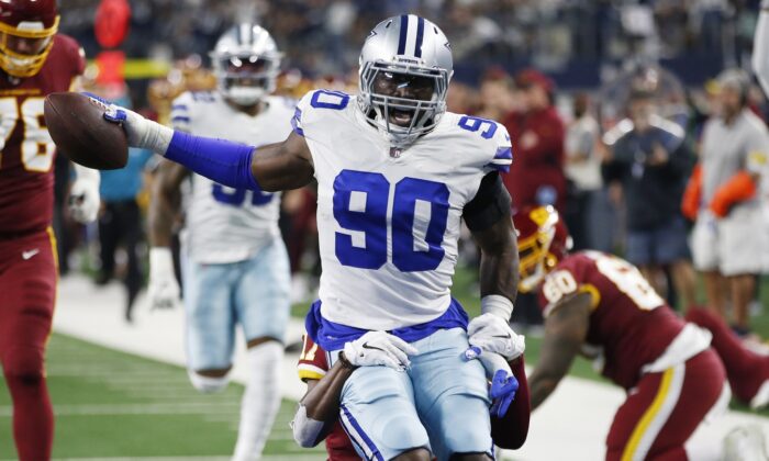 Dallas Cowboys defensive end Demarcus Lawrence (90) returns an interception for a touchdown in the first quarter against the Washington Football Team at AT&T Stadium, in Arlington, Texas, on Dec. 26, 2021. (Tim Heitman/USA TODAY Sports via Field Level Media)