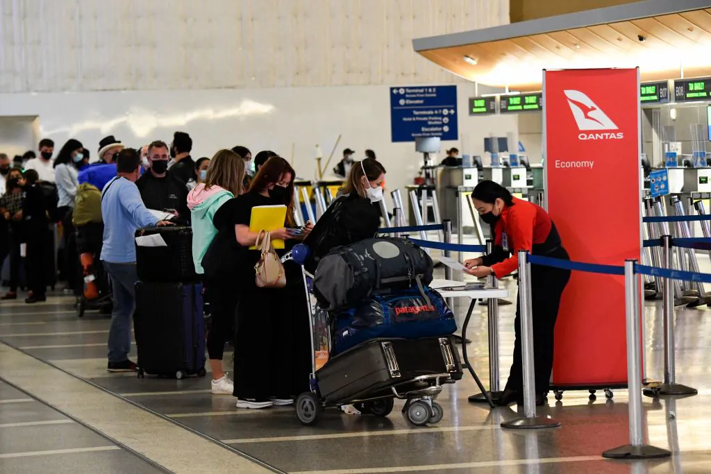 Travelers wait in line to verify their Covid-19 vaccination status as they check-in for a flight to Sydney, Australia at Los Angeles International Airport in Los Angeles, California, on Nov. 1, 2021. (Patrick T. Fallon/ AFP via Getty Images)