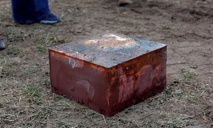Workers recover a box believed to be the 1887 time capsule that was put under Confederate Gen. Robert E. Lee's statue pedestal in Richmond, Va., on Dec. 27, 2021. (Eva Russo/Richmond Times-Dispatch via AP)