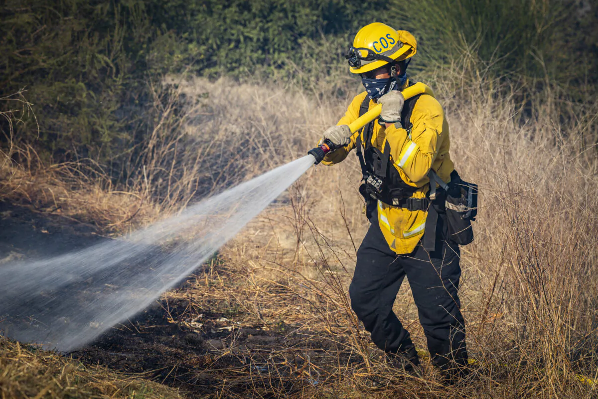 Firefighters work to extinguish the Bond Fire burning in Silverado Canyon, Calif., on Dec. 3, 2020. (John Fredricks/The Epoch Times)