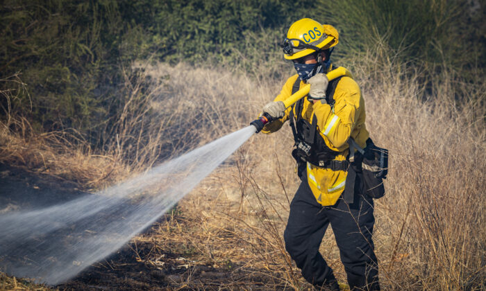 Firefighters work to extinguish the Bond Fire burning in Silverado Canyon, Calif., on Dec. 3, 2020. (John Fredricks/The Epoch Times)
