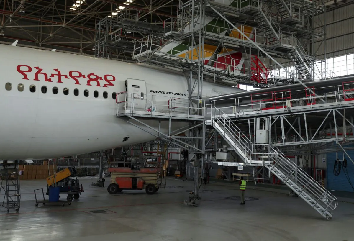 A worker is seen near an Ethiopian Airlines passenger carrier to be converted into a cargo plane at the Ethiopian Airlines hangar within the Bole international airport in Addis Ababa, Ethiopia, on May 15, 2020. (Giulia Paravicini/Reuters)