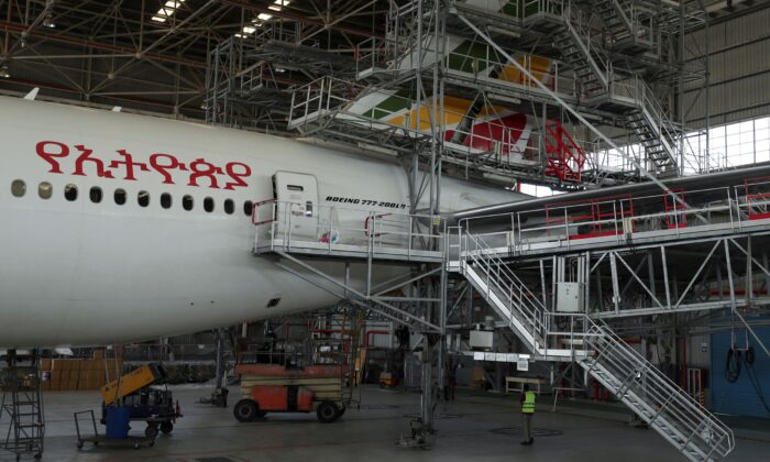 A worker is seen near an Ethiopian Airlines passenger carrier to be converted into a cargo plane at the Ethiopian Airlines hangar within the Bole international airport in Addis Ababa, Ethiopia, on May 15, 2020. (Giulia Paravicini/Reuters)