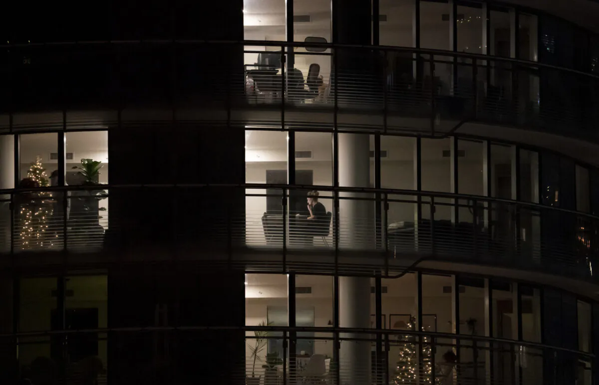 A woman is seen working on a computer at her apartment in downtown Vancouver on Dec. 3, 2020.  COVID-19 restrictions are forcing more people work from home. (Jonathan Hayward/The Canadian Press)