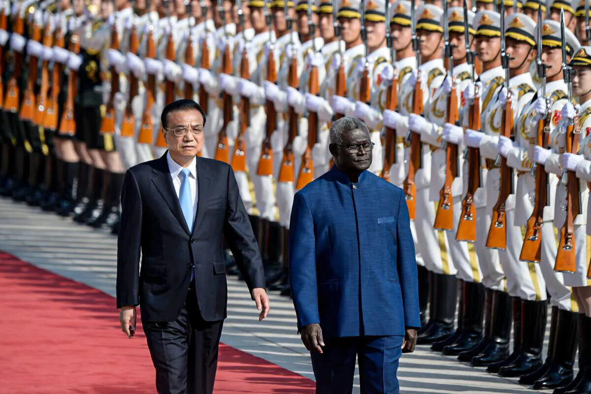 Solomon Islands Prime Minister Manasseh Sogavare and Chinese Premier Li Keqiang inspect honor guards during a welcome ceremony at the Great Hall of the People in Beijing on Oct. 9, 2019. (Wang Zhao/AFP via Getty Images)