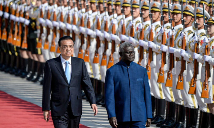 Solomon Islands Prime Minister Manasseh Sogavare (R) and Chinese Premier Li Keqiang inspect honour guards during a welcome ceremony at the Great Hall of the People in Beijing on Oct. 9, 2019. (Wang Zhao/AFP via Getty Images)