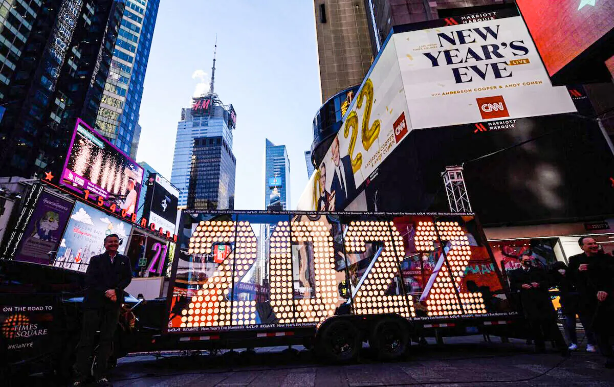 People pose for photos before the 2022 numerals to be used at a New Year's countdown event in Times Square in New York, on Dec. 20, 2021. (Ed Jones/AFP via Getty Images)