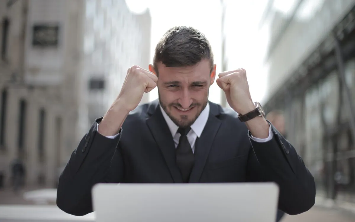 Stock photo of a business man achieving an accomplishment. (Andrea Piacquadio/Pexels)