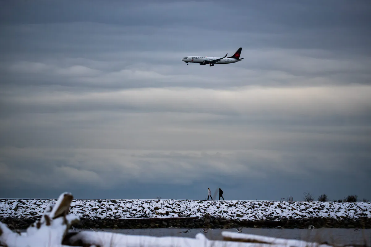 A plane prepares to land at Vancouver International Airport, in Richmond, B.C., on Dec. 26, 2021. (Darryl Dyck/The Canadian Press)